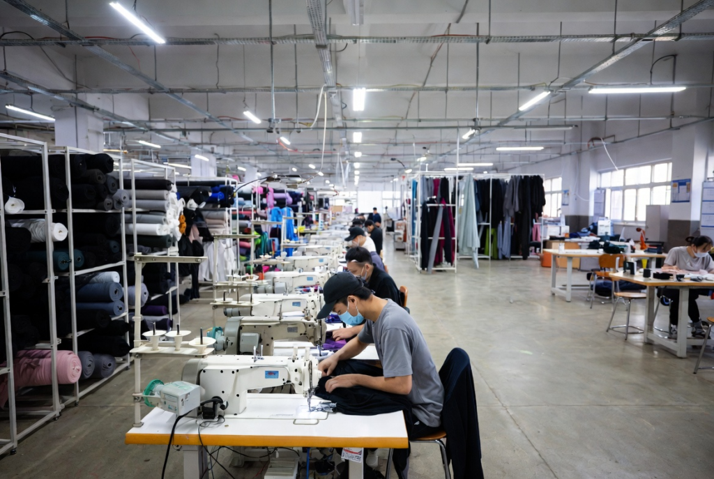 Interior of a Guangzhou clothing factory showing efficient production lines for streetwear apparel – direct access to the China supply chain advantage.