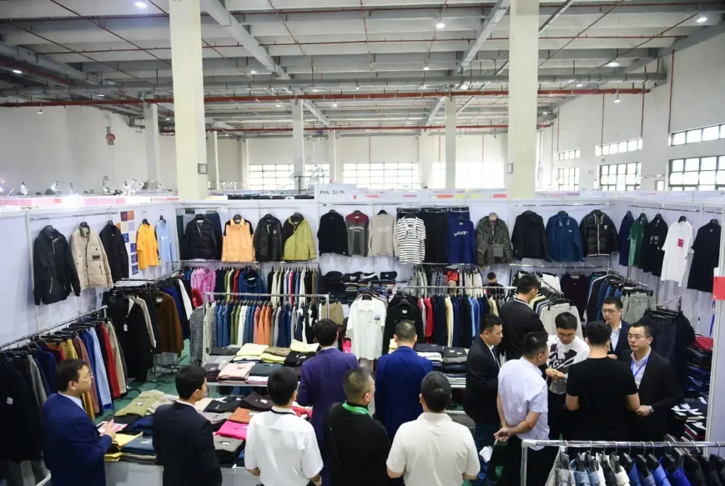Canton Fair Phase 3 hall packed with streetwear manufacturer booths and global buyers negotiating apparel orders – ideal for visualizing the scale of sourcing opportunities.
