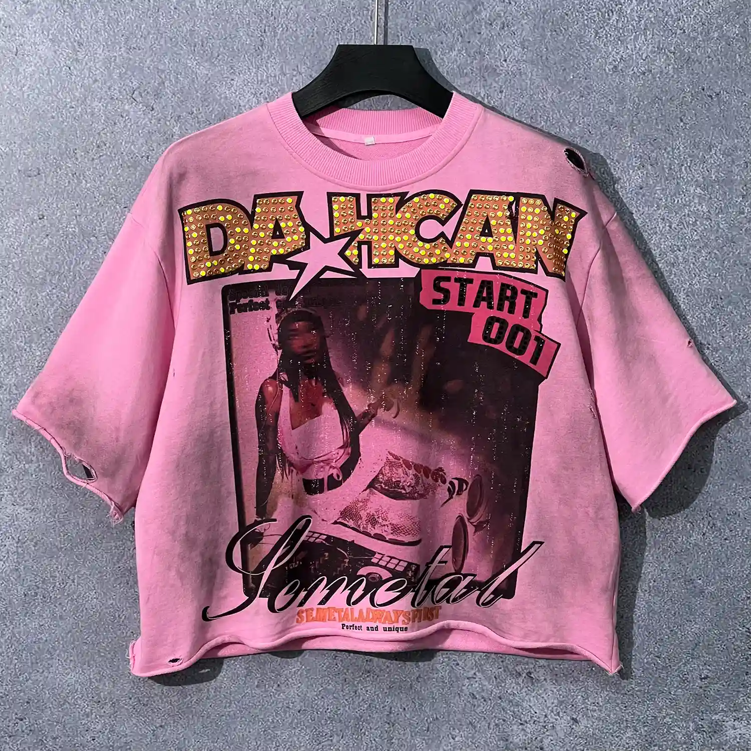 Front view of custom rhinestone distressed t-shirt in vintage washed pink featuring Y2K graphics.