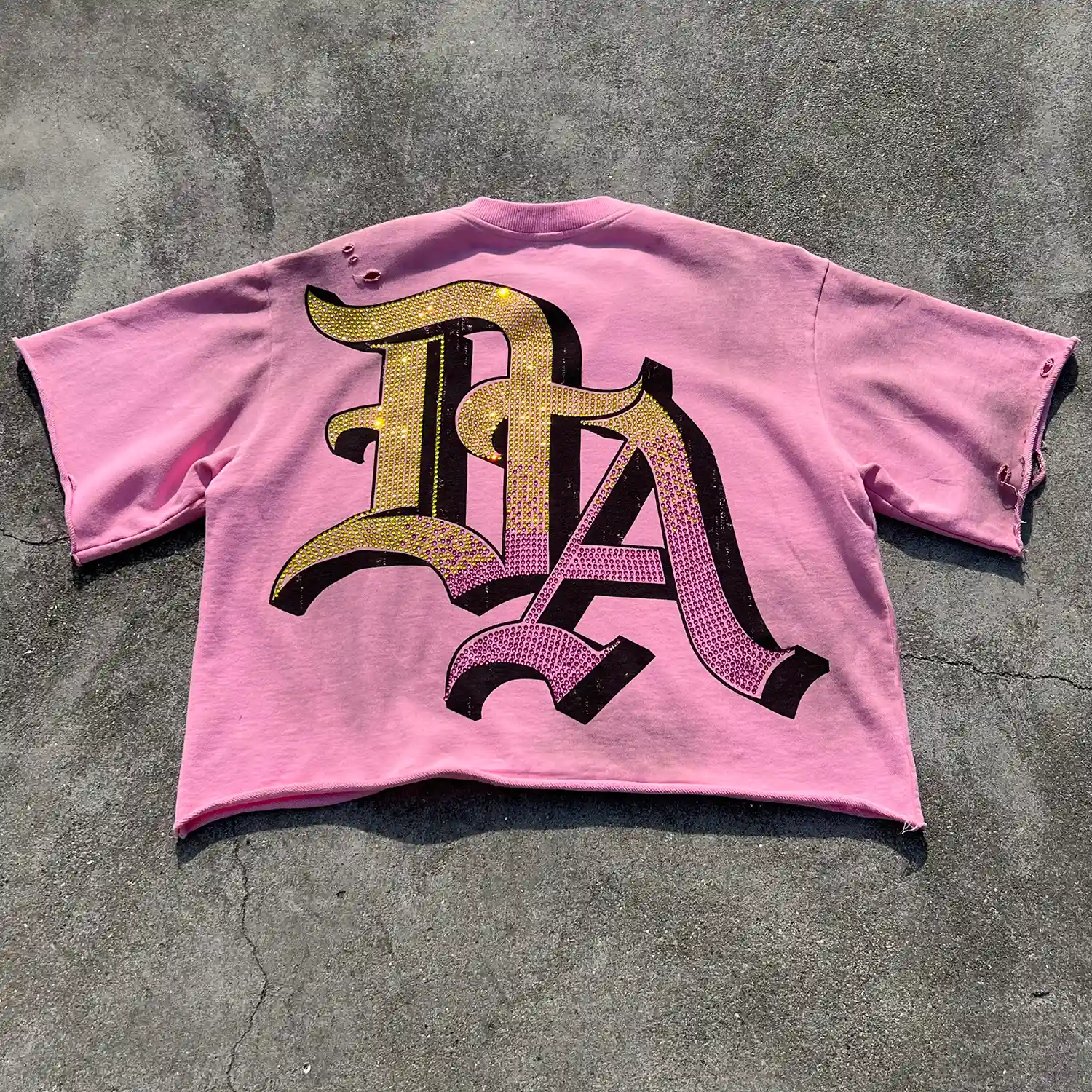 Flat lay of the back displaying heavy rhinestone coverage for B2B apparel buyers.